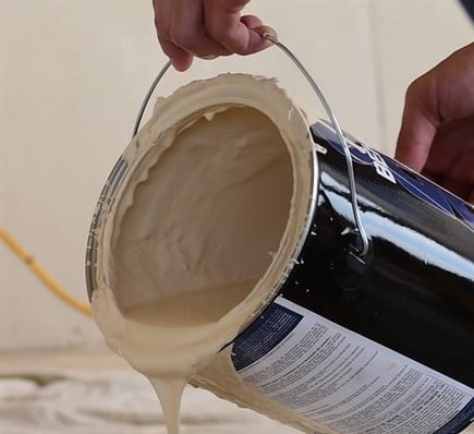 Paint Pouring From A Can To Show How To Remove Paint From Carpet