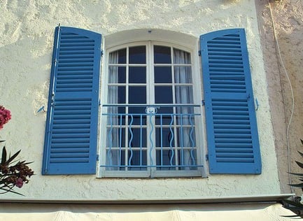 Painting Shutters On A Window In Light Blue