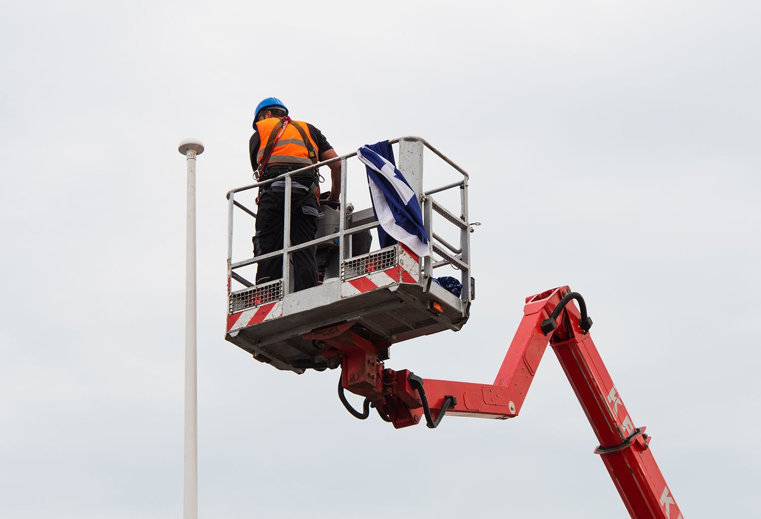 Painter on lift working on commercial building