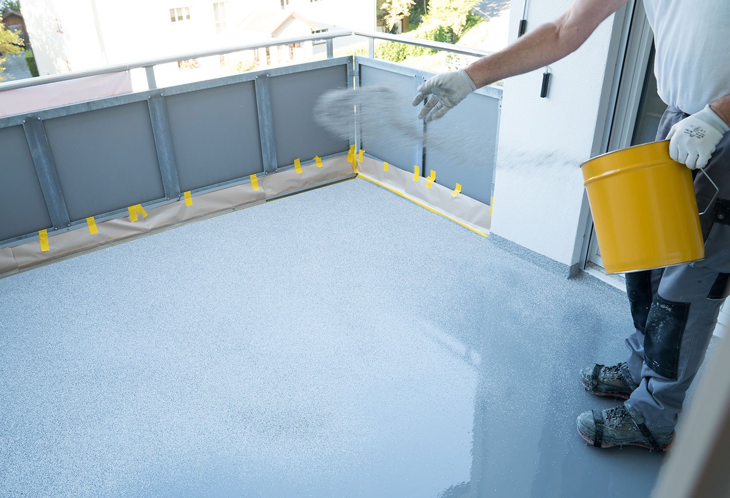 Worker applying epoxy floor coating